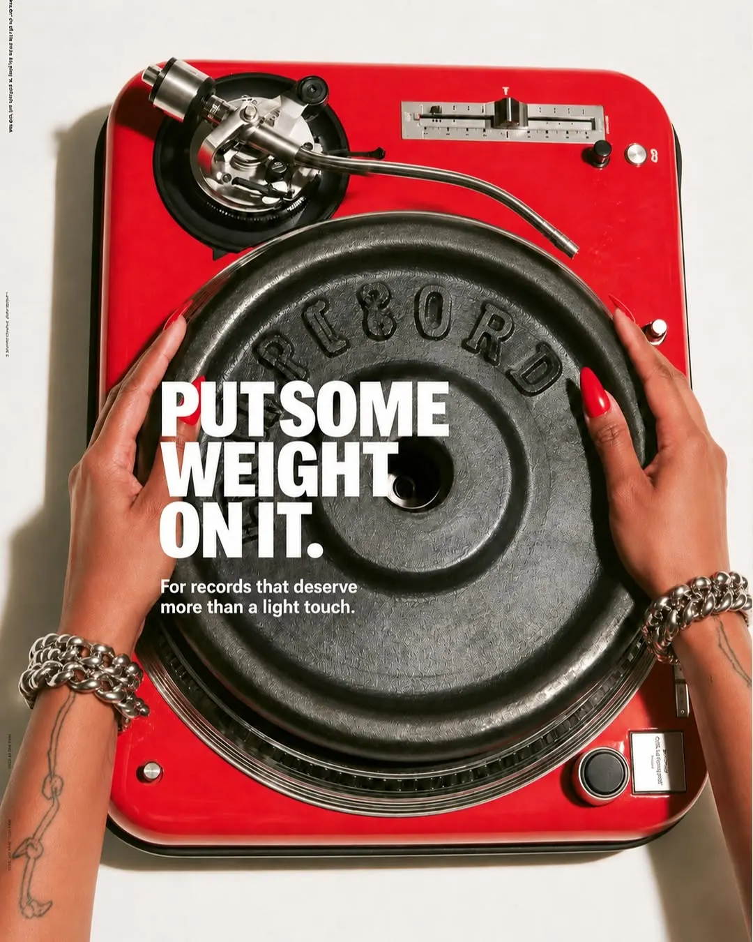 Hands holding a red turntable-style speaker with the headline Put some weight on it