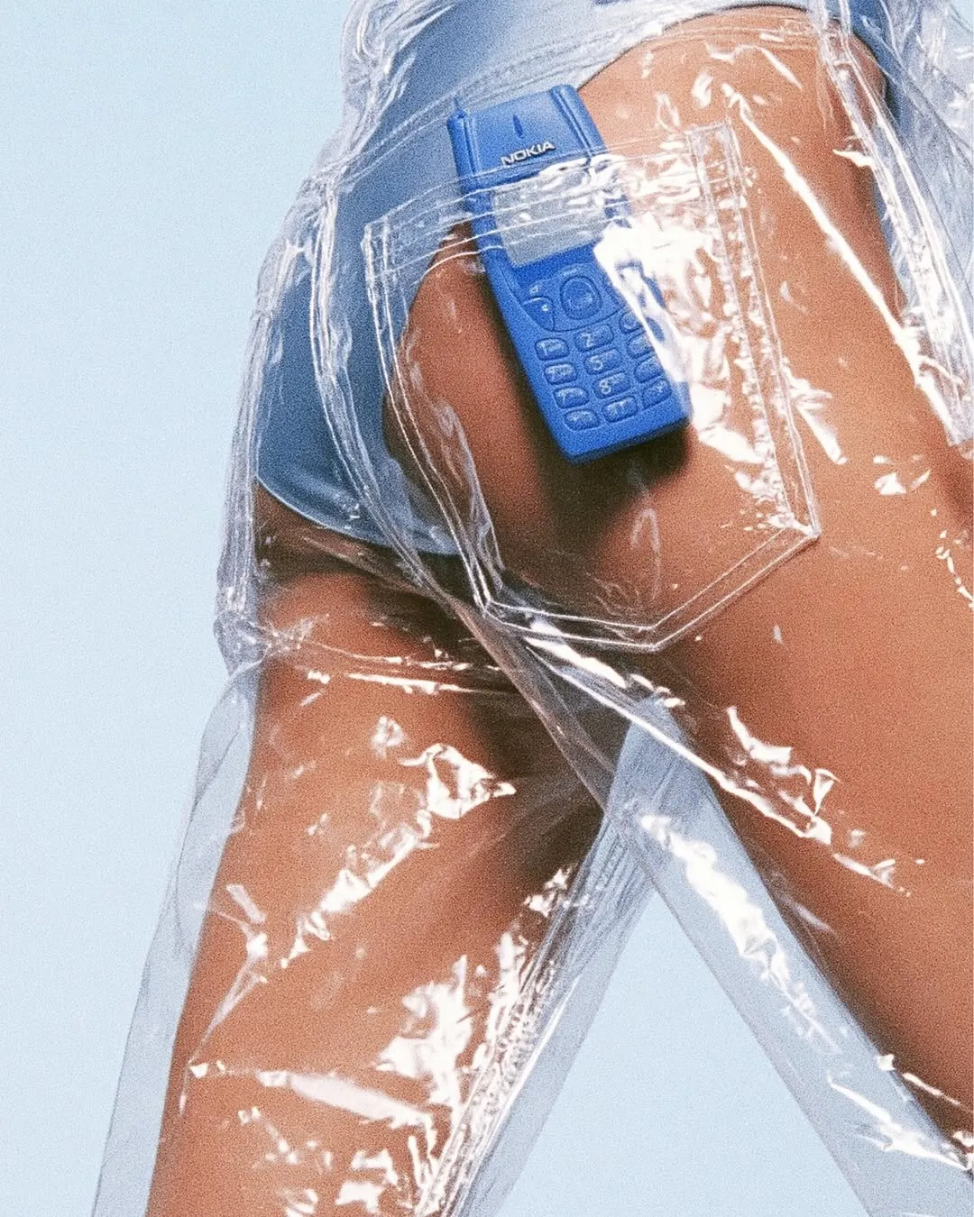 Blue-painted body wrapped in clear plastic film